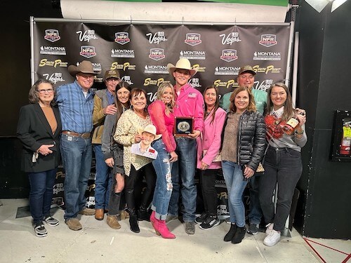 Kincade Henry holding a trophy alongside his family